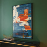 Modern abstract wall art with blue and orange brushstrokes in stylish home decor setting