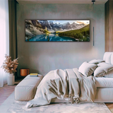 Modern bedroom with neutral bedding, large mountain landscape wall art, and minimalist decor