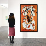 Woman viewing abstract orange and black wall art in modern gallery, Fansee Australia decor