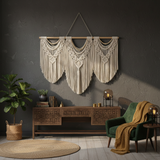 Boho living room with artisan wall macrame, carved console table, green chair, and cozy decor.